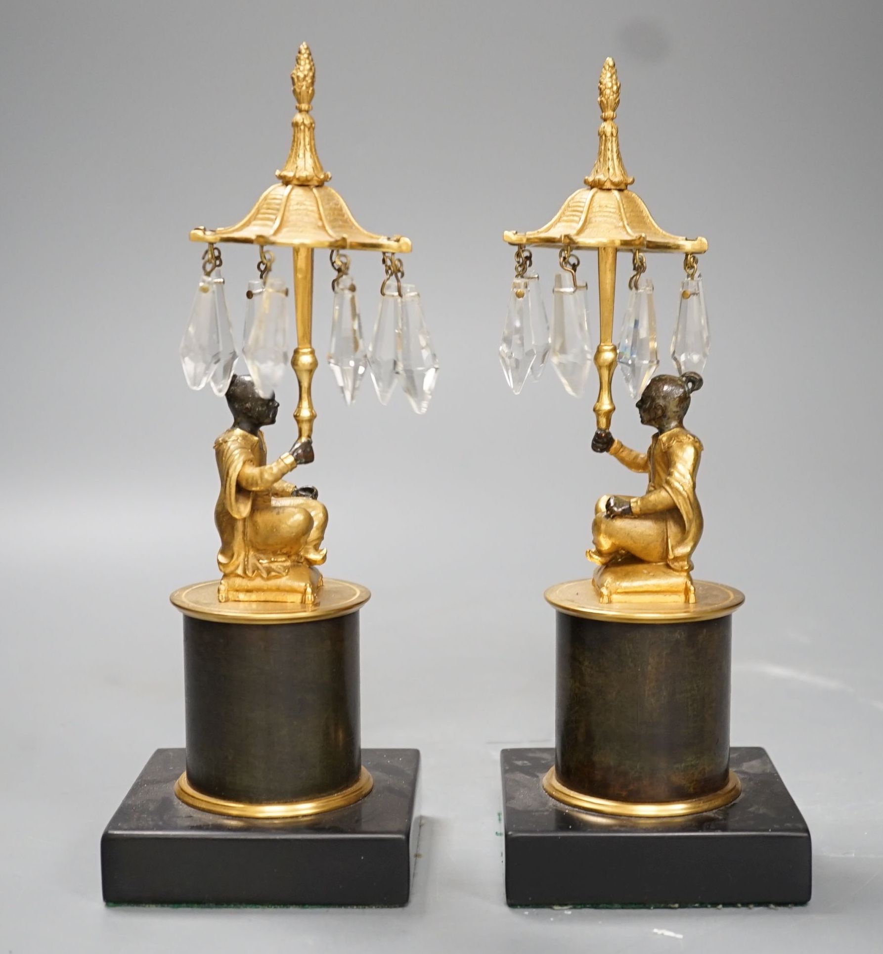 A pair of Louis XVI style bronze chinoiserie lustres depicted plinth seated gentleman bearing umbrella lustre drops - 23cm tall